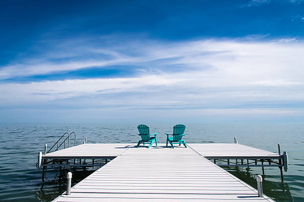 istock Muskoka or Adirondack Chair on a dock 625007290