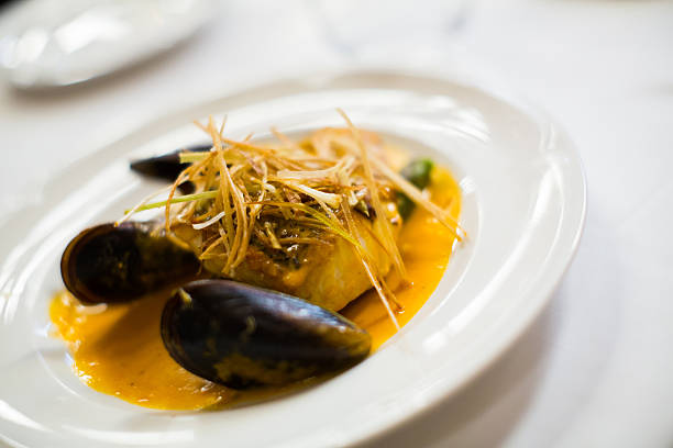 istock baked white fish with mussels 625007502
