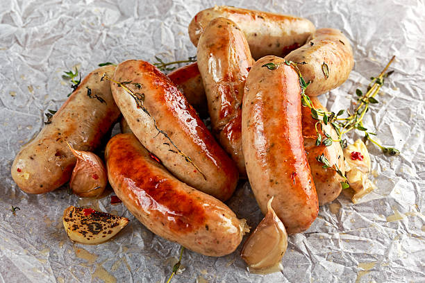 istock Home-made Pork Sausages on crumpled paper with thyme 625007584