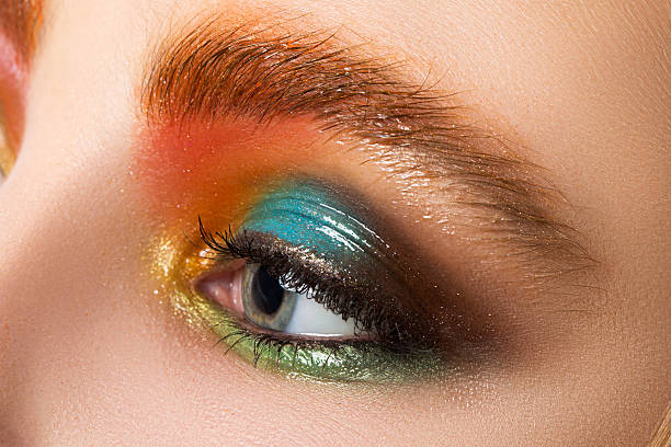 Close-up view of women eye with beautiful modern make-up Close-up view of women eye with beautiful modern make-up. Multicolored somey eyes. Wet makeup. eyeshadow stock pictures, royalty-free photos & images