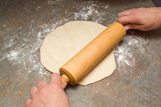 istock Rolling dough with a wooden roller. Homemade pastries. Christmas time. 625009052