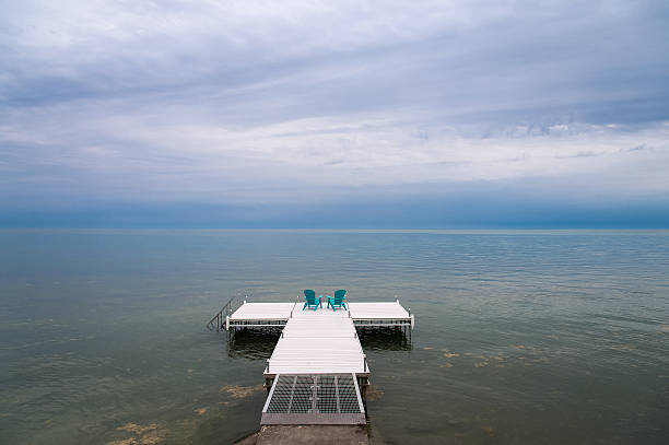 istock Adirondack or Muskoka Chair on a dock 625010308