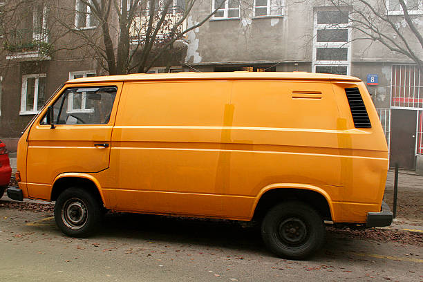 istock Old orange transit car on street 625011160