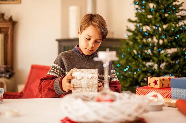 istock Little Boy Opening his Christmas Present 625011348