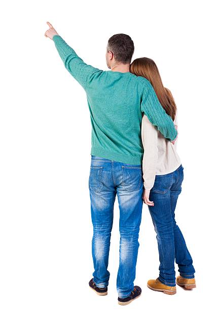 istock young couple pointing at wal Back view 625036994