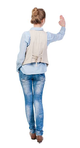 istock Young woman in vest presses down on something. 625037142