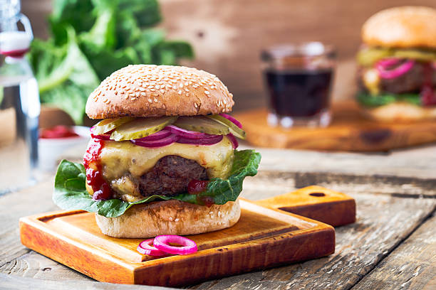 istock Burger with  gherkins, red onion and lettuce 625041680