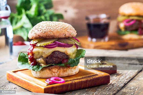 Burger With Gherkins Red Onion And Lettuce Stock Photo - Download Image Now - Onion, Pickled, Burger