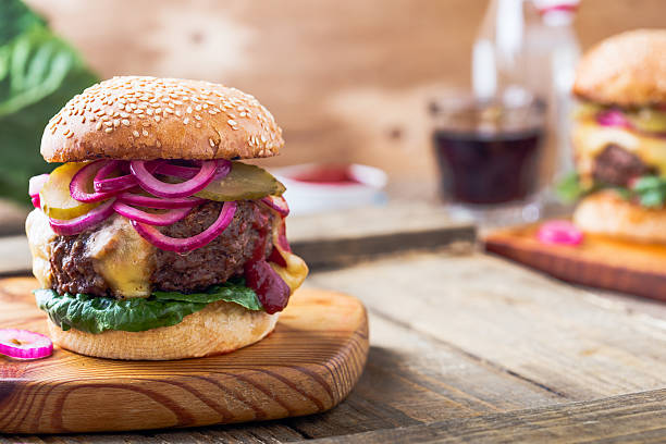 istock Burger with  gherkins, red onion and lettuce 625041782