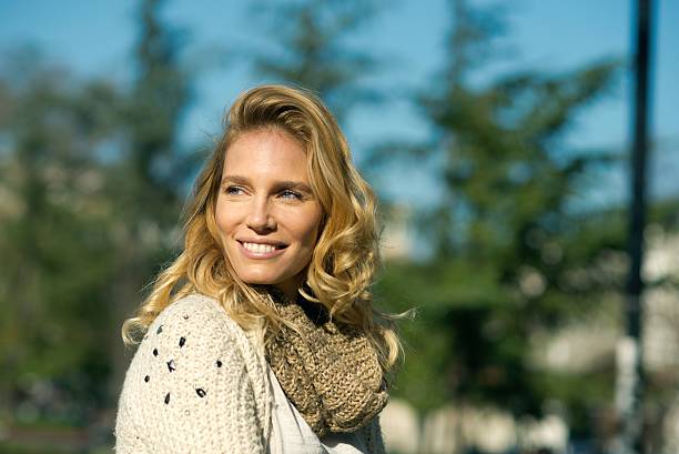 Portrait of an beautiful blondy smiling woman looking away