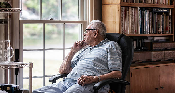istock Day Dreaming Elderly Senior Man Staring Through Hazy Window 625049856