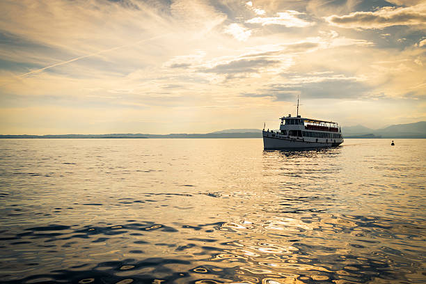 White ferry on Lake Garda at sunset.