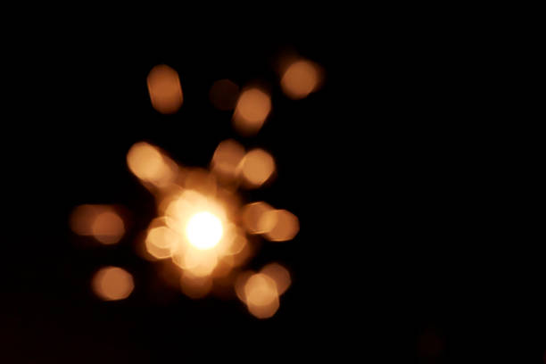 Bright yellow line of sparkling lights in darkness. Use for abstract celebration concept.