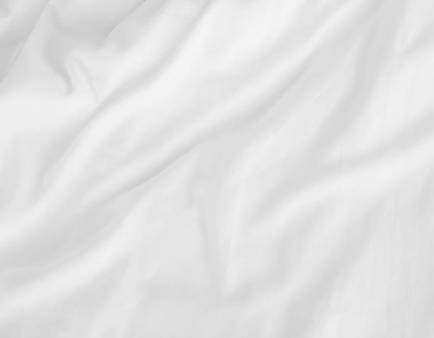 white bed sheets stock photo