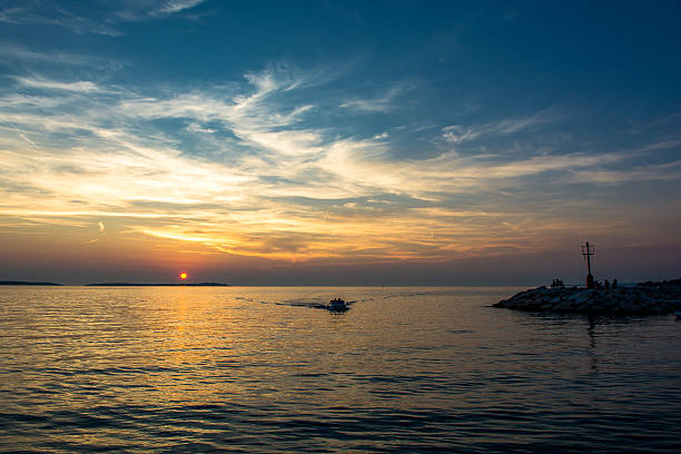 istock Boat Returns to Harbor at Sunset in Croatia 625059266