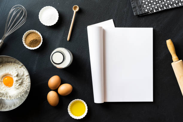 istock Baking recipe, folded magazine with white blank pages on blackboard 625060186