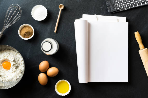 istock Baking recipe, folded magazine with white blank pages on blackboard 625060882