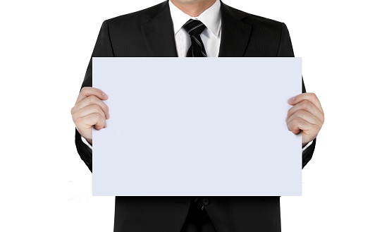 Man in suit holding blank sign board with hand