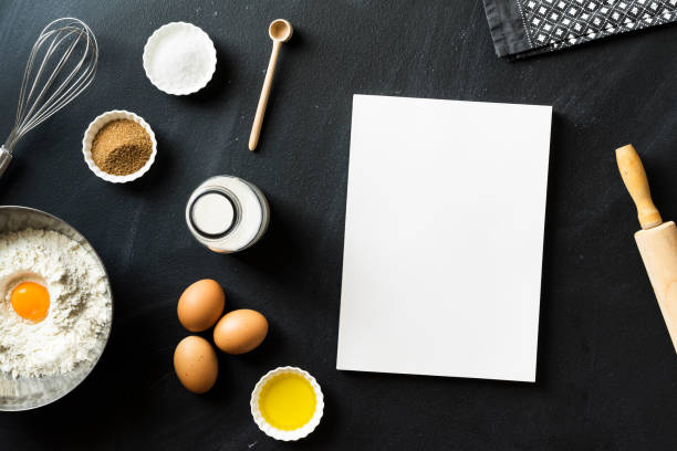 istock Baking recipe, blank white cover magazine on blackboard 625063284