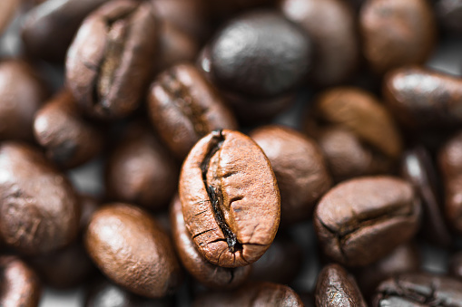 Close up heap of roasted brown coffee beans. coffee beans background