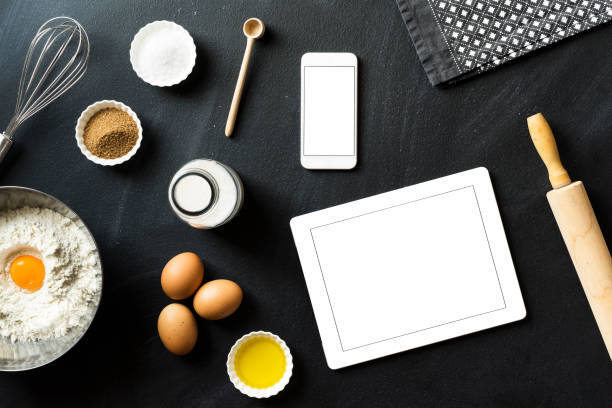 istock Online baking recipe, blank screen mobile devices on blackboard 625066922