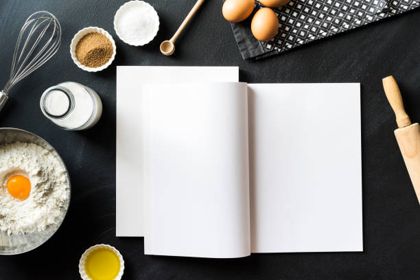 istock Baking recipe, open magazine with white blank pages on blackboard 625067980