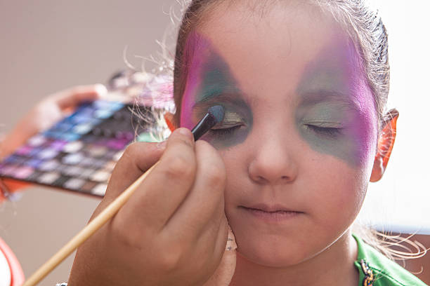 istock Little cute girl making facepaint before halloween party 625068144