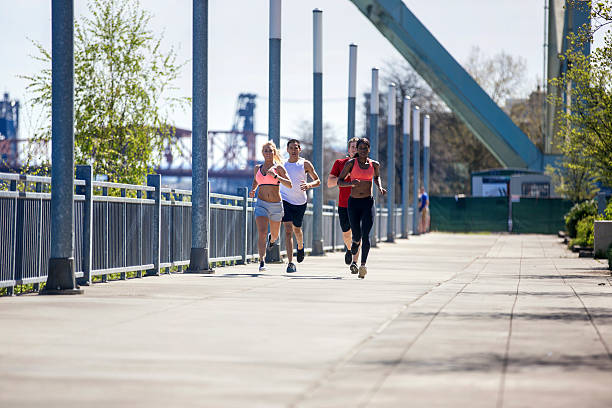istock Diverse group of young adults running in an urban environment 625080026