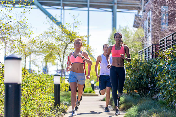 istock Diverse group of young adults running in an urban environment 625080034