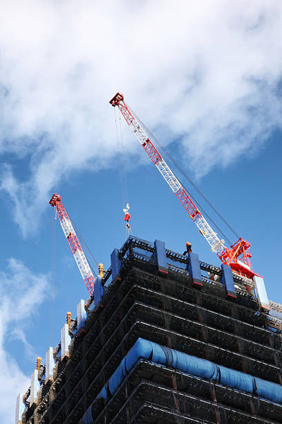 istock Crane and building construction site against blue sky 625081512
