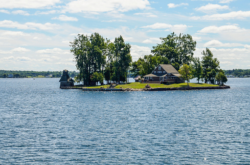 Kingston, Canada - July 24, 2014: One island with house in the Saint Lawrence river in the Thousand Islands on the Canadian side of the archipelago