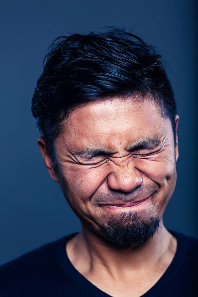 istock Man looking very uncomfortable and distraught and in pain 625094574