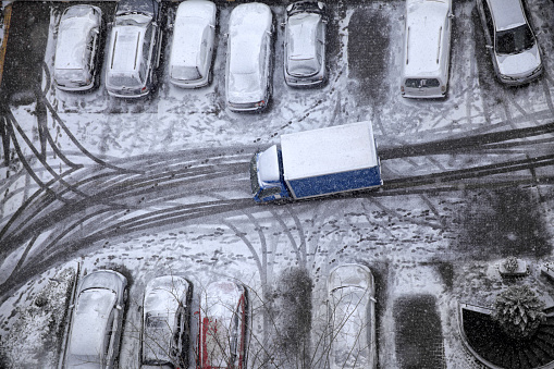 elevated view of delivery truck in snow covered street