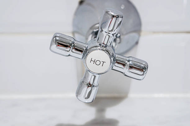 Stainless faucet for hot water in the bathroom stock photo