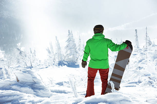 istock Snowboarder stands top mountain snowboard 625121814