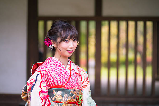 Young furisode girl sitting on bench