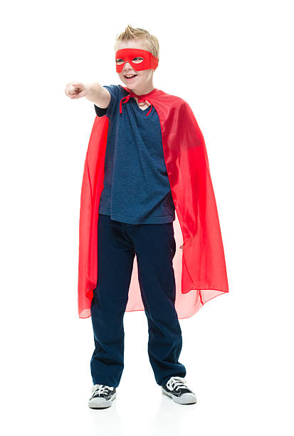 istock Smiling little superhero pointing away 625125808