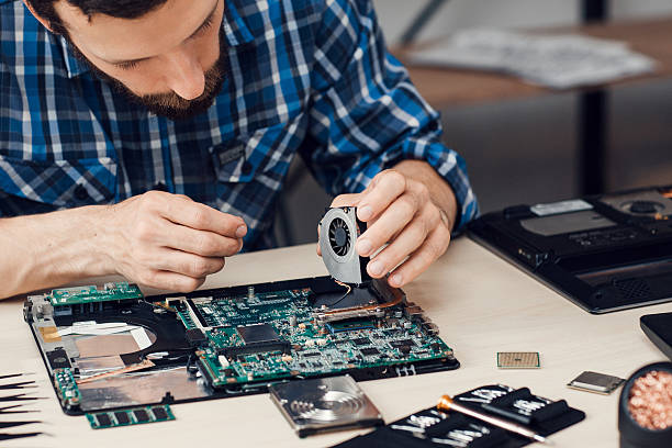 istock Repairman disassembling laptop motherboard 625135532