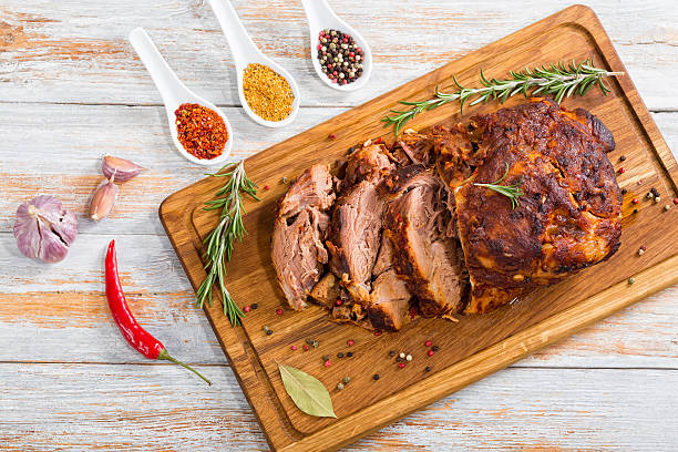 istock Oven-Barbecued Pork shoulder cut on slices on chopping board 625135598
