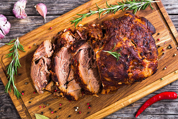 istock Oven-Barbecued Pork shoulder, cut on slices on chopping board 625135712