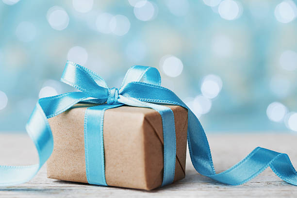 istock Christmas gift box against blue bokeh. Holiday greeting card. 625143394