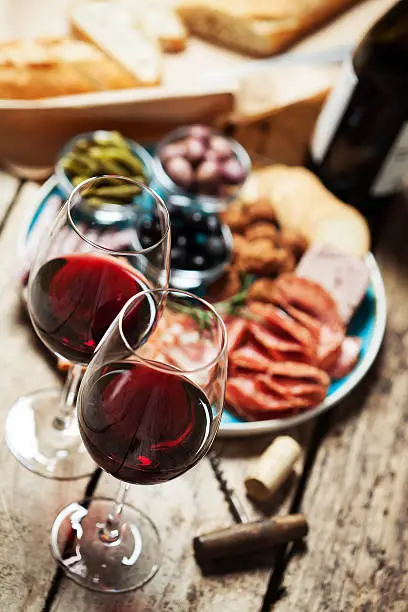 Red wine with charcuterie assortment on the backgroundRed wine with charcuterie assortment on the background