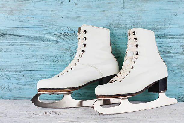 istock Vintage ice skates for figure skating on turquoise background. 625144918