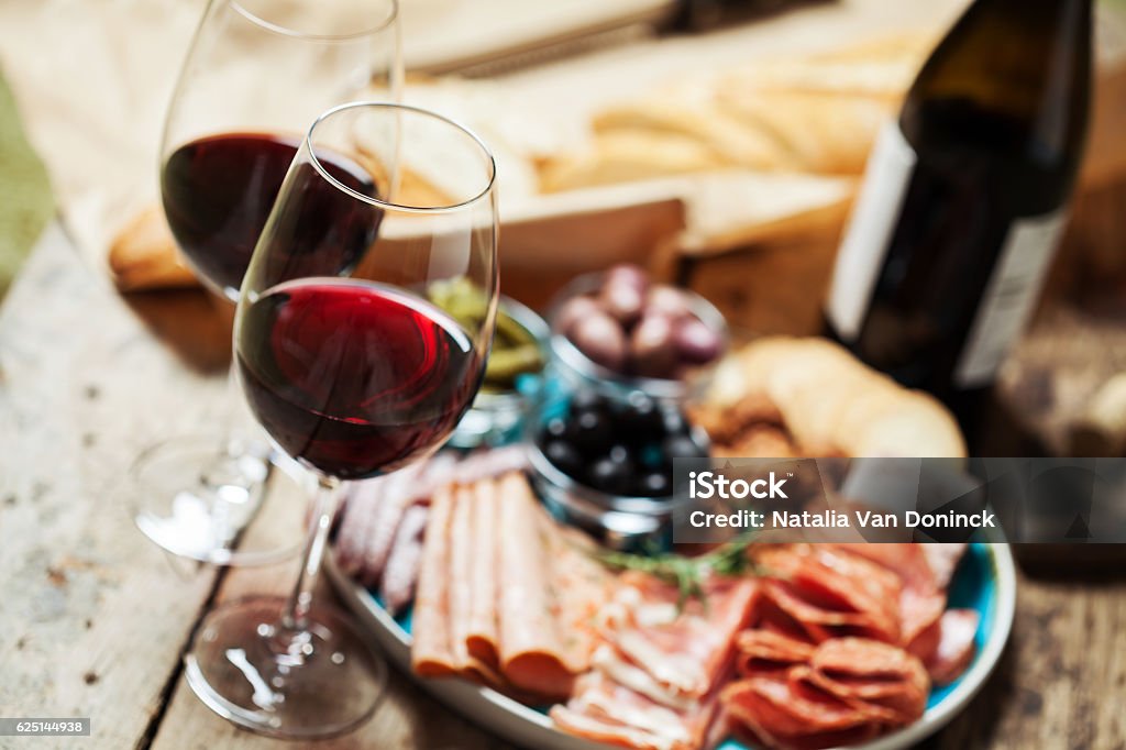 Red wine Red wine with charcuterie assortment on the backgroundRed wine with charcuterie assortment on the background Wine Stock Photo