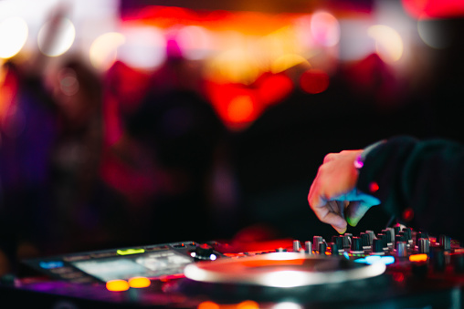 Clubbing and nightlife - turntable and headphones in a nightclub.