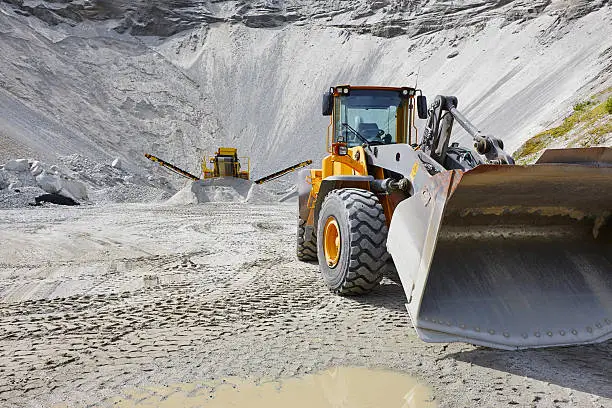 Quarry aggregate with heavy duty machinery. Construction industry. Horizontal