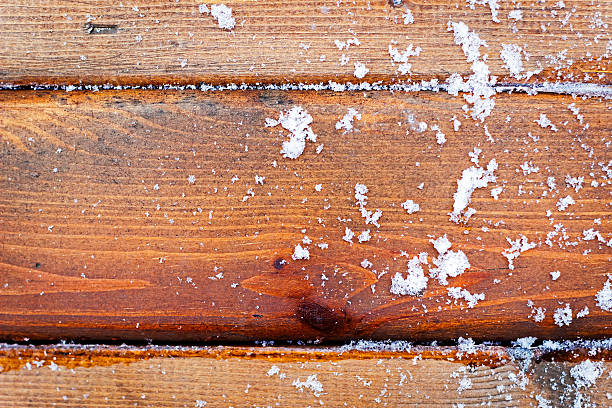 istock Old wooden background with falling snow flakes 625149148