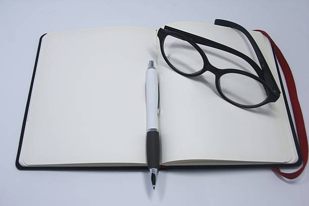 istock Glasses on top of book 625149848