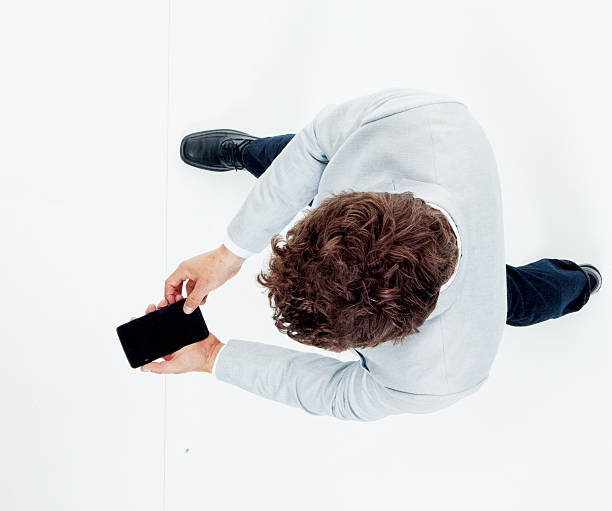 istock Above view of smart casual man using phone 625150312