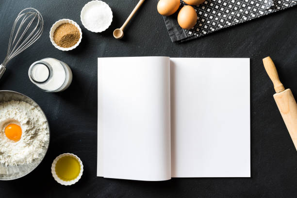 Baking recipe, open magazine with white blank pages on blackboard